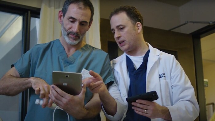 Male doctor and male nurse checking out the product